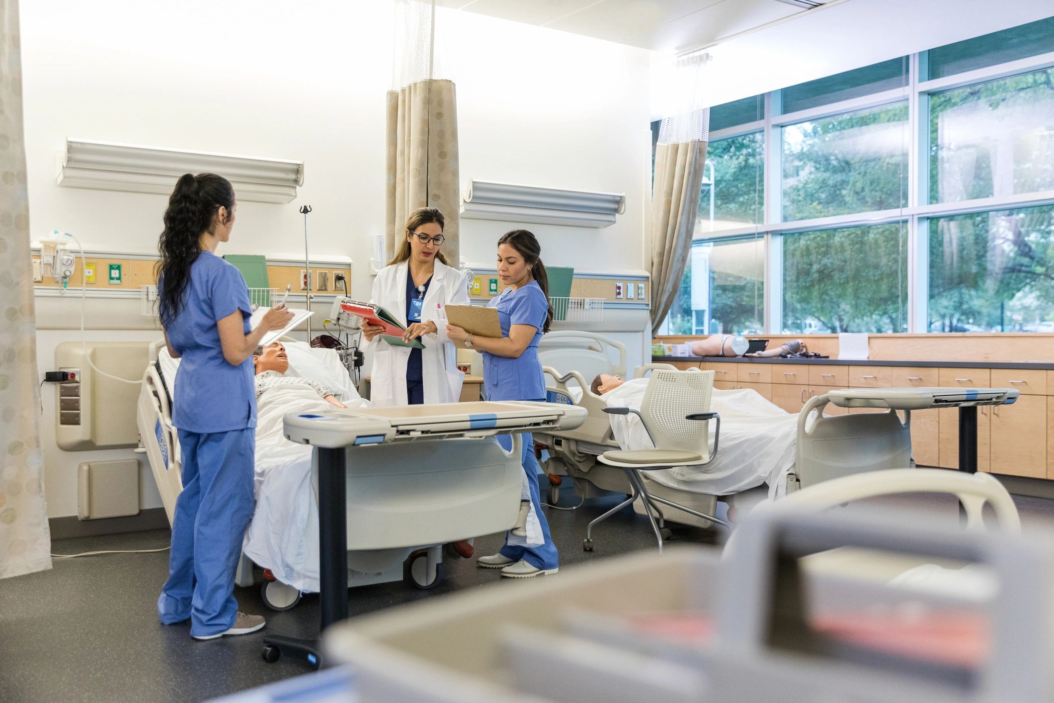 Clinical instructor teaching interns in a medical classroom