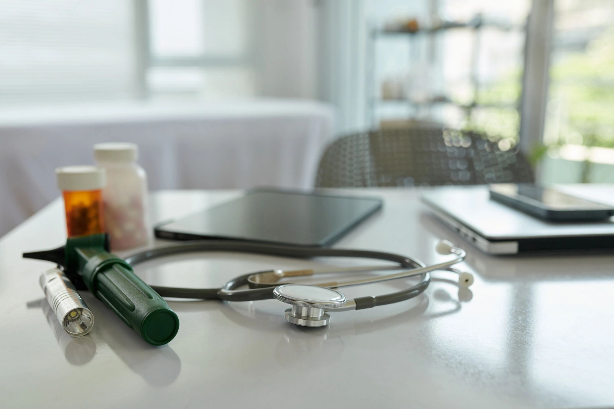 Stethoscope and medical tools on a clinician’s desk