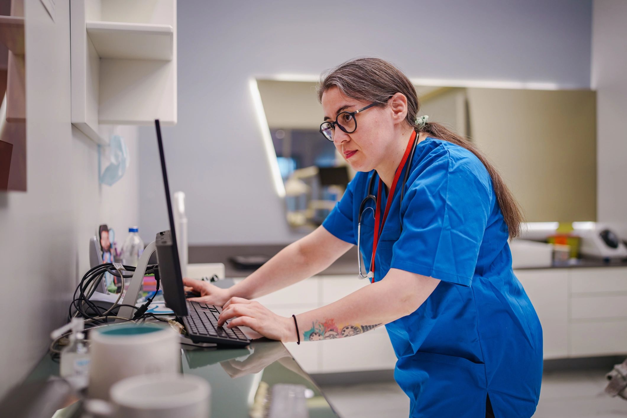Nurse studying and managing learning resources at a computer
