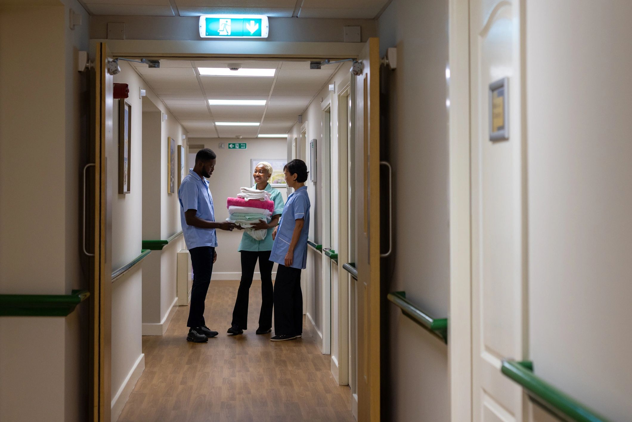 Healthcare team discussing patient care in a clinical corridor